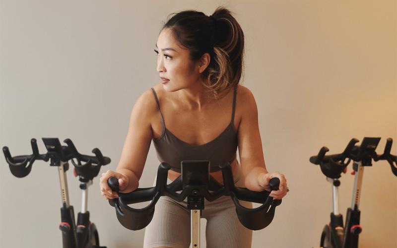 a woman riding a stationary bike